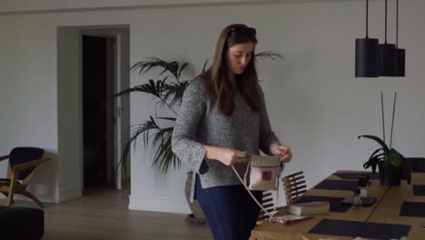 Woman-preparing-to-leave-minimalist-Scandanavian-flat