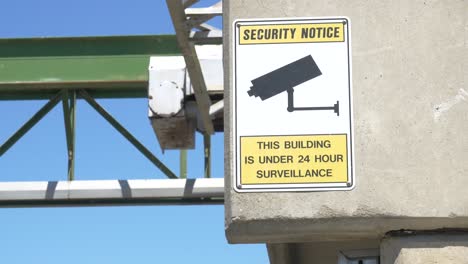 Under-surveillance-sign-hung-outside-warehouse-to-protect-employees
