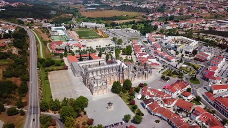 Aerial-opening-landscape-shot-of-Batalha-Monastery,-Portugal