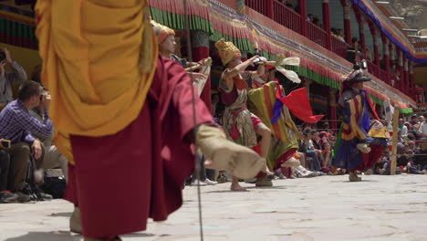 Closeup-of-feet-dancing-at-Hemis-festival-in-Monastery,-tourists-watching-the-festival