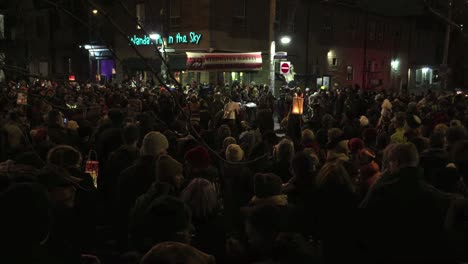 Night-time-community-festival-gathering-before-the-Festival-of-Lights-in-Kensington-Market,-as-people-prepare-to-welcome-the-Winter-Solstice