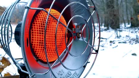 Close-up-of-a-gas-propane-heater-in-the-snow