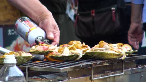 Close-up-man-cooks-oysters-on-the-gass-grill