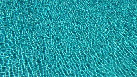 4k-footage-of-swimming-pool-water-shimmering-in-the-sun-light