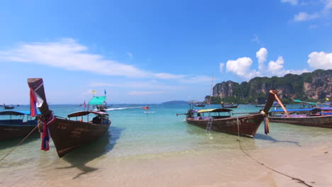 left-to-right-panning-shot-of-mooring-boats-on-beautiful-white-sand-Railay-beach-in-Thailand-Asia-at-60fps-and-4K-downscaled-to-1080p