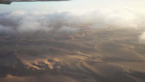 Wide-Epic-shot-of-Namibian-Sossuvlei-from-a-Small-Airplane,-with-Nice-Shadows-and-Small-Clouds