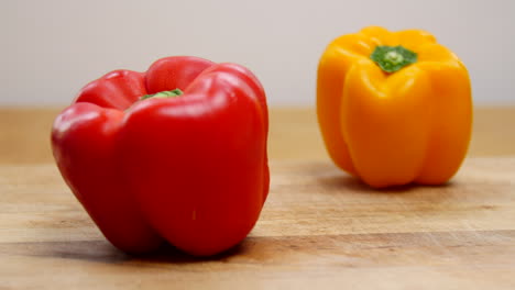 Yellow-and-red-bell-peppers-on-a-cutting-board