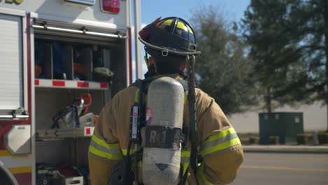 Firefighter-walking-towards-firetruck-after-a-firefighting-and-rescue-operation