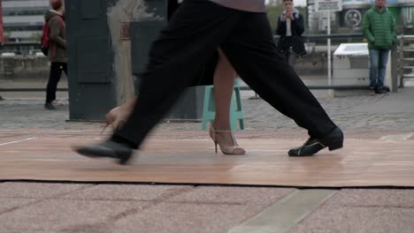 FOLLOW-CLOSE-UP-Feet-of-skilled-tango-dancers-dancing-for-tip-on-Puerto-Madero