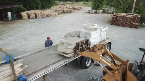 Building-stone-loaded-onto-a-truck-with-forklifts