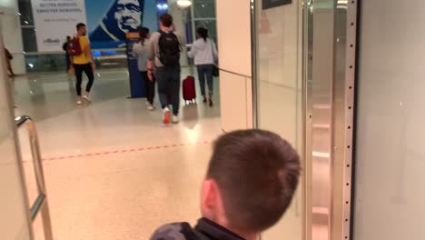 Boy-passing-through-the-one-way-exit-doors-of-the-San-Jose-International-Airport