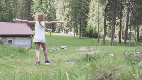 Little-girl-with-red-hair-runs-in-the-meadow-of-the-woods-slow-motion-100-fps