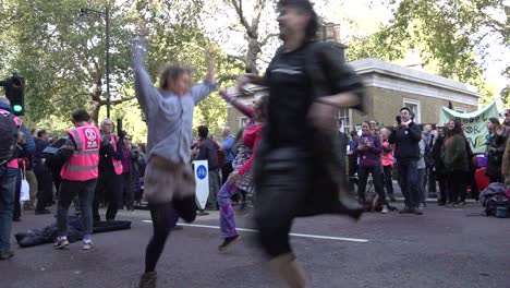 Protesters-dance-during-the-Extinction-Rebellion-protests-in-London,-UK