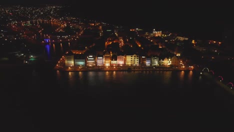Nighttime-aerial-view-of-the-floating-Qeen-Emma-bridge-connecting-the-Punda-and-Otrobanda-neighbourhoods-of-Willemstad,-Curacao