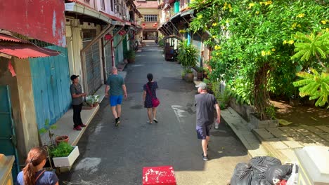 Group-of-tourist-walking-into-the-suburb-area-of-Malacca-with-tour-guide