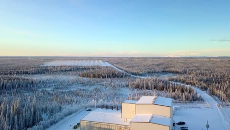 Aerial,-rising,-drone-shot,-over-the-HAARP-Alaska-facility,-on-a-cold-and-sunny,-winter-day,-in-Gakona,-USA