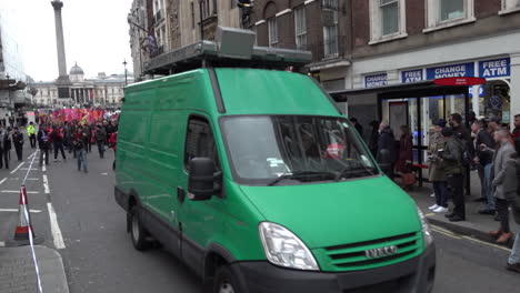 A-green-unmarked-police-facial-recognition-surveillance-van-drives-slowly-at-the-front-on-an-environmental-protest