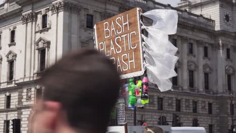 Bash-plastic-trash-sign-with-plastic-bottles-and-bags-in-London-street,-closeup-view