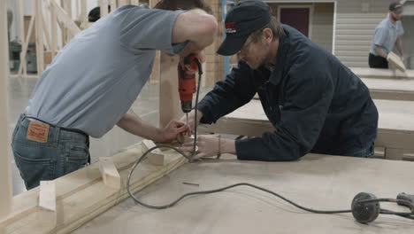 Carpentry-instructor-and-student-work-together-on-a-building-project-at-a-trade-school