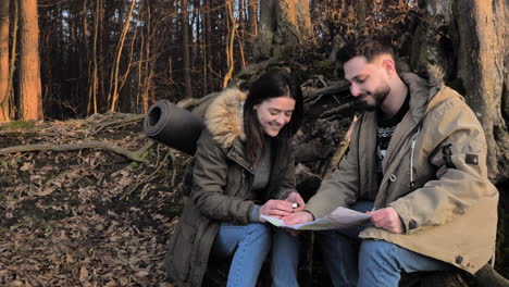 Caucasian-couple-checking-map-in-a-forest.