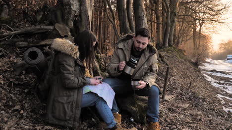 Caucasian-couple-checking-map-in-a-forest.