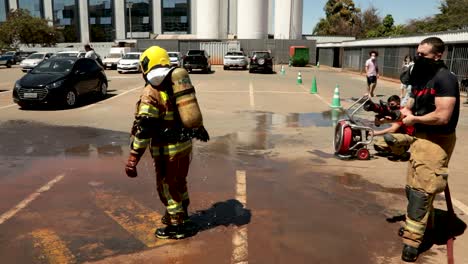 Firefighters-decontaminate-by-being-sprayed-down-with-water-after-entering-the-COVID-19-Santa-Luzia-hospital