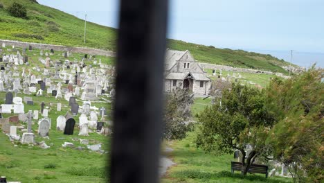 Llandudno-coastal-mountain-chapel-cemetery-graveyard-dolly-through-fence-landscape