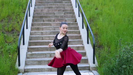 Beautiful-female-dancer-does-a-dance-routine-outside-next-to-the-stairs