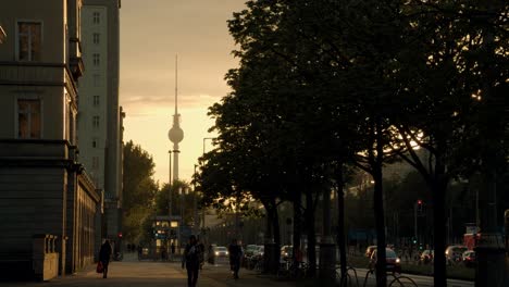 Pedestrian-on-Sidewalk-during-Beautiful-Sunset-with-Lovely-Fernsehturm
