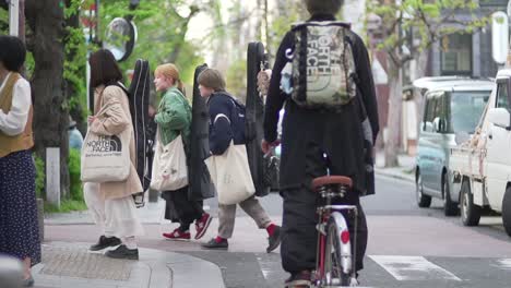 Japanische-Musiker-Gehen-Und-überqueren-Tagsüber-Die-Straße-In-Kyoto,-Japan