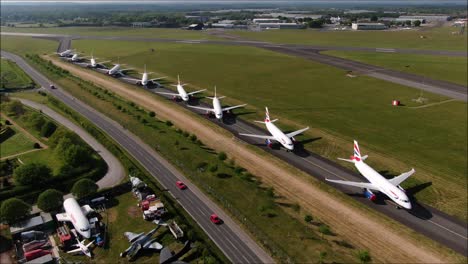 Aerial-drone-shot-of-Planes-parked-up-on-taxiway-at-Gatwick-Airport-because-of-COVID-19-lockdown