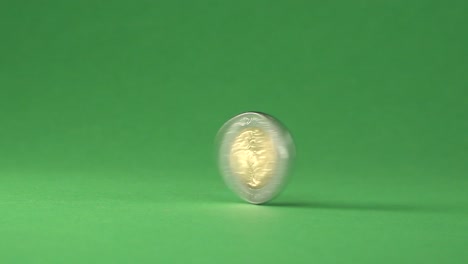 A-Mexican-5-pesos-coin-spinning-from-right-to-left-on-a-chroma-background