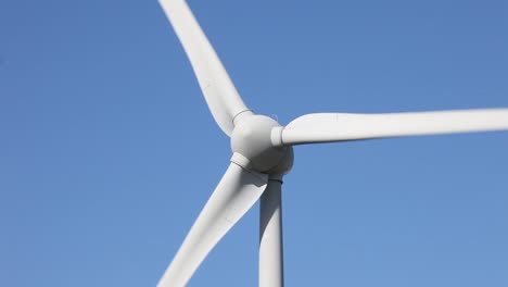 Close-up-of-wind-turbine-against-a-blue-sky