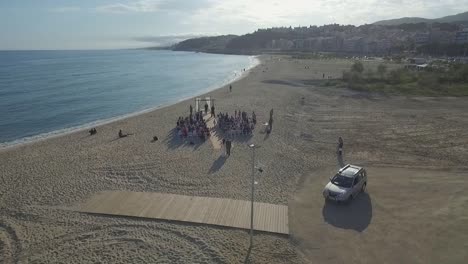 Bride-walks-to-the-altar-on-a-small-idyllic-beach-wedding-in-the-catalan-coast-of-Spain