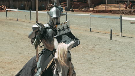 Slow-motion-shot-of-medieval-knight-with-lance-riding-horse-on-joust-tournament