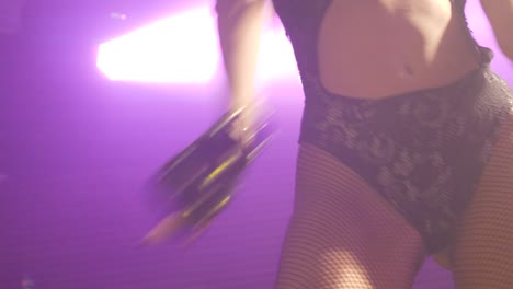 Close-up-of-an-exotic-dancer-as-she-dances-onstage-at-an-adult-night-club-dressed-in-retro-80s-clothes