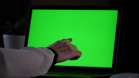 Typing,-showing-something-on-a-laptop-with-green-screen,-decisively-pressing-the-enter-return-key