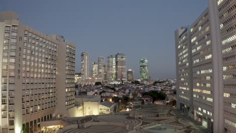 Fly-between-Buildings-in-Tel-Aviv-city,-night,-drone-shot,-city-view
