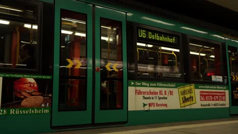 A-green-subway-train-departing-from-the-station-in-Frankfurt,-Germany
