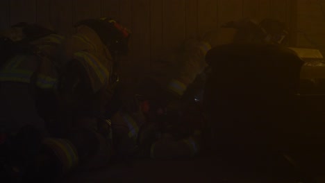 Firefighters-rescues-an-injured-firefighter-inside-a-smoky-burning-building