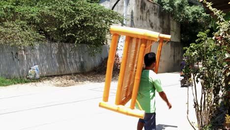 Filipino-bamboo-craftsman-personally-hawking-his-varnished-handmade-bamboo-platform-to-sell-it-as-a-single-bed-on-the-streets-in-rural-Cebu,-Philippines