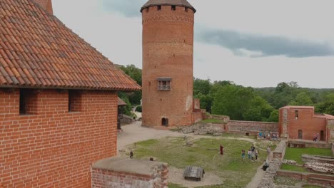 Aerial-shot-going-down-focused-on-the-main-tower-of-Turaida,s-Castle-in-Latvia