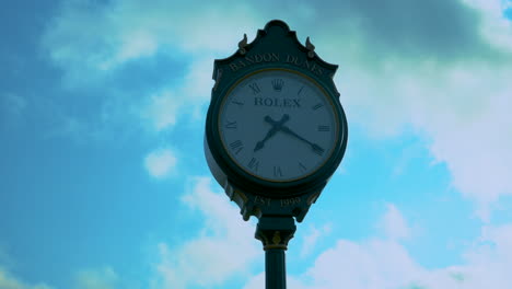 Large-Rolex-clock-at-Bandon-Dunes-Golf-Resort,-evening,-nice-cloud-movement,-zooming-in