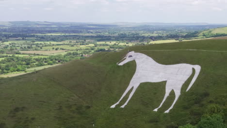 Aerial-Clockwise-Orbit-of-the-Westbury-White-Horse-on-a-Summer’s-Day-with-Hikers-Walking-Around-Perimeter-of-Horse-with-Narrow-Crop