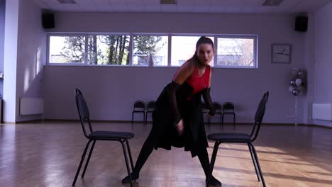 Professional-female-dancer-dances-around-two-chairs