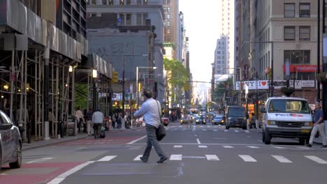 Crossing-a-street-in-Manhattan-in-180-fps-slow-motion-at-Broadway,-Manhattan,-New-York-City-facing-north-at-Zuccotti-Park-on-a-summer-afternoon