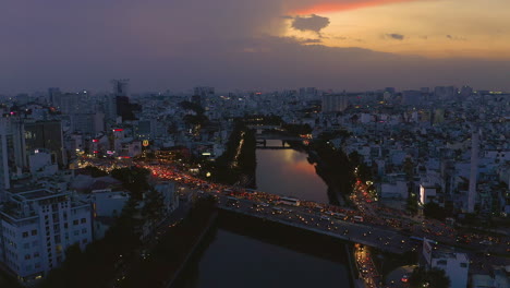 Evening-sunset-drone-footage-looking-over-Dien-Bien-Phu-Bridge-the-Hoang-Sa-canal-area-of-Binh-Thanh-district,-Saigon-or-Ho-Chi-Minh-City,-Vietnam