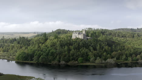 An-aerial-view-of-Carbisdale-Castle-on-a-sunny-morning-with-cloudy-skies