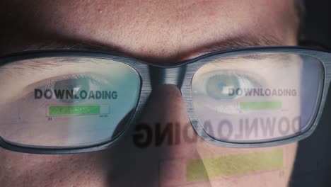 Computer-screen-is-reflected-on-man's-glasses---Access-granted-and-Download-is-started---Close-up