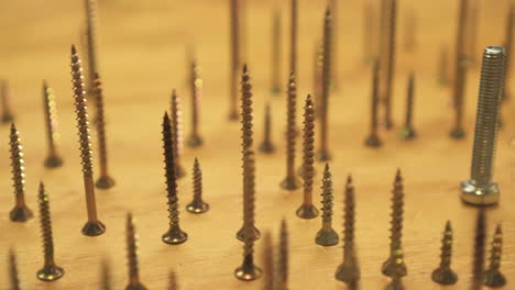 Concept-of-odd-one-out,-numerous-bronze-screws-circle-single-large-silver-bolt
